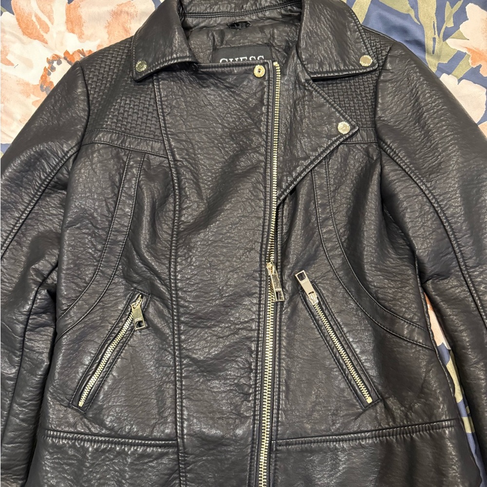 Guess black leather jacket, nice acrylic/polyester interior. Polyester exterior.